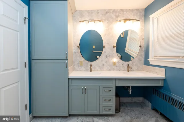 a bathroom with a double vanity sink and a mirror