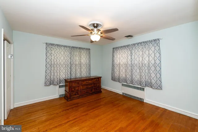 a view of room with window and ceiling fan