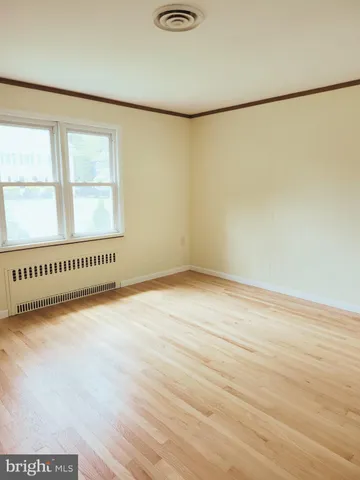 a view of an empty room and a window