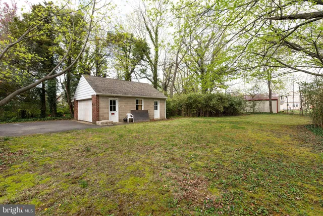 a front view of a house with yard and green space