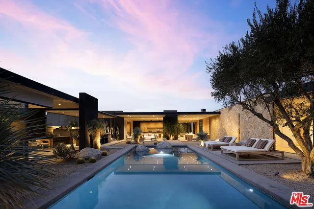 a view of yard with swimming pool and furniture