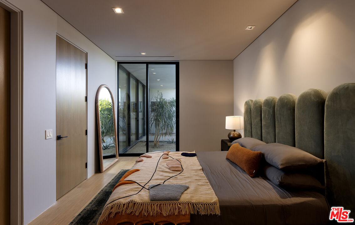 2 Echo Lane Rancho Mirage, CA 92270 - Photo 18 of 37 a bedroom with bed and glass door