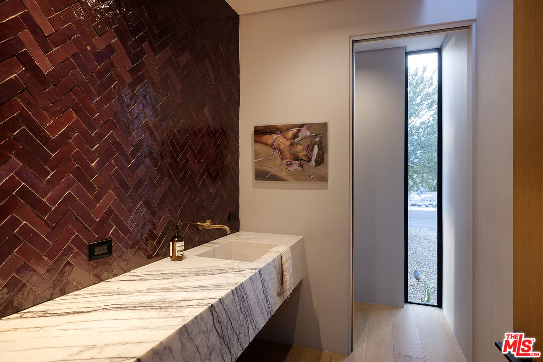 2 Echo Lane Rancho Mirage, CA 92270 - Photo 23 of 37 a bathroom with a granite countertop sink and a mirror