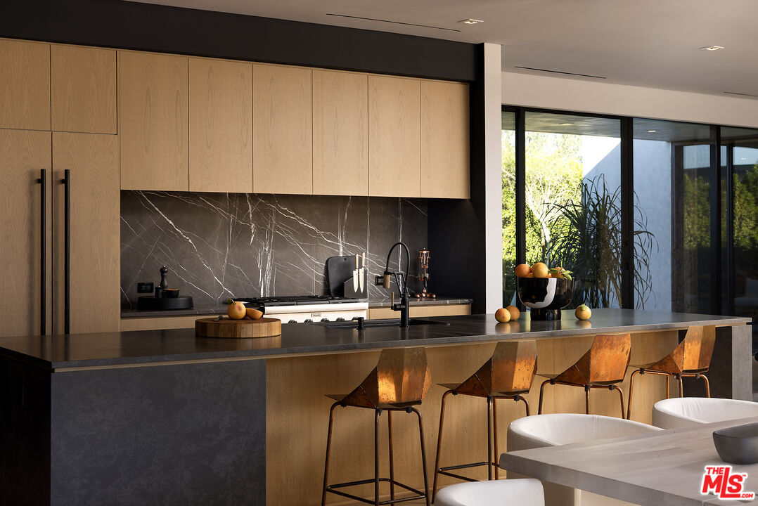 2 Echo Lane Rancho Mirage, CA 92270 - Photo 3 of 37 a kitchen with stainless steel appliances kitchen island granite countertop a sink and cabinets