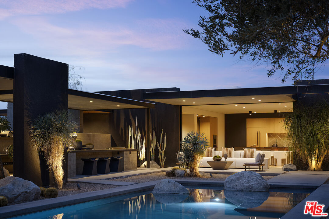 2 Echo Lane Rancho Mirage, CA 92270 - Photo 34 of 37 a living room with furniture a flat screen tv and a fireplace