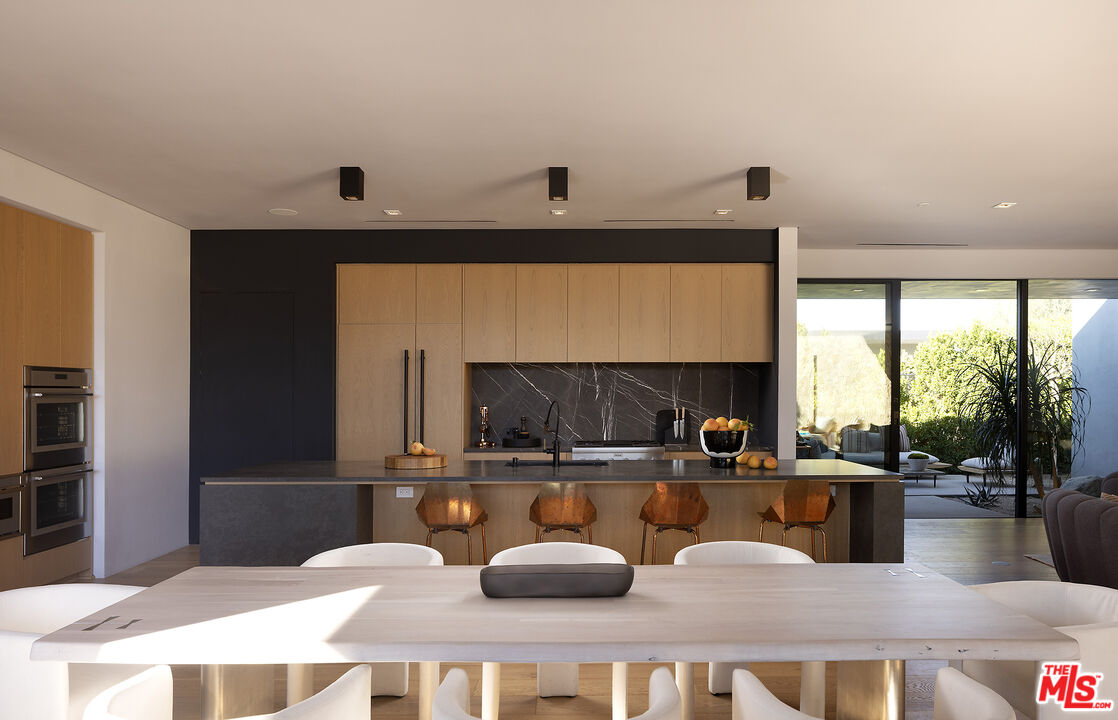 2 Echo Lane Rancho Mirage, CA 92270 - Photo 5 of 37 a kitchen with a sink and a refrigerator
