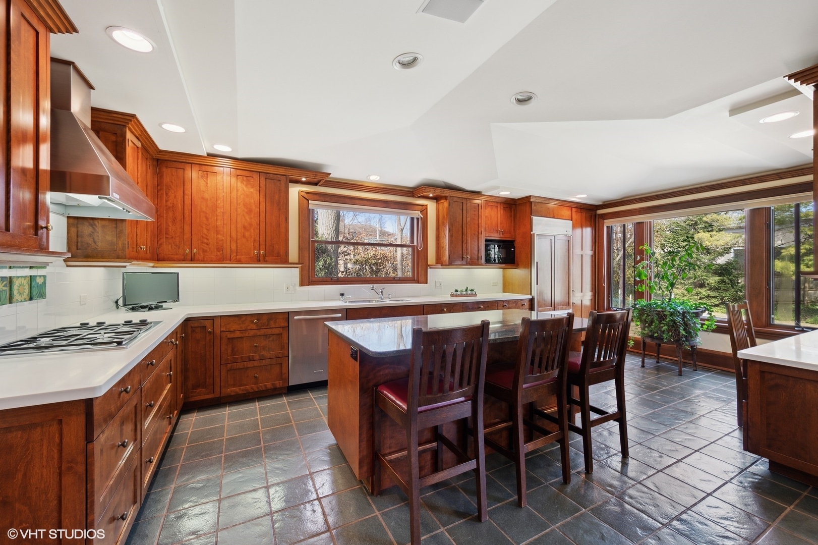 881 Private Road Winnetka, IL 60093 - Photo 17 of 60 a kitchen with stainless steel appliances granite countertop table chairs sink and cabinets