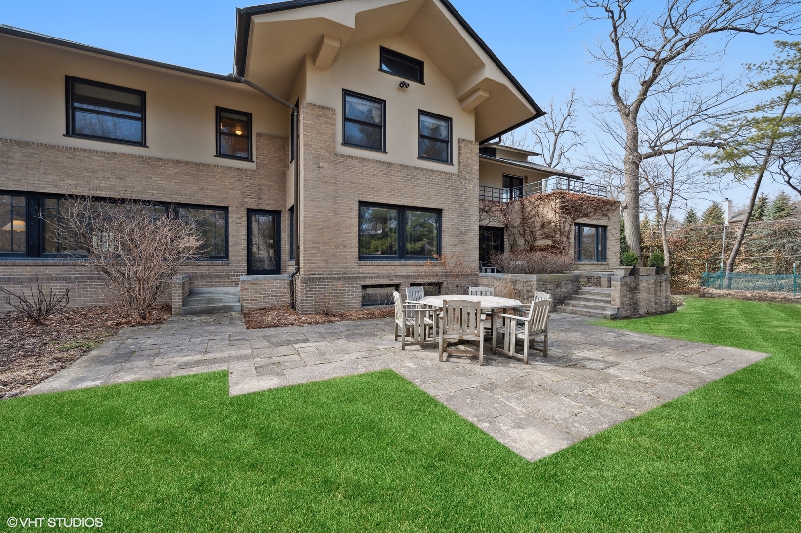 881 Private Road Winnetka, IL 60093 - Photo 49 of 60 a view of a patio with table and chairs with a fire pit and a large tree