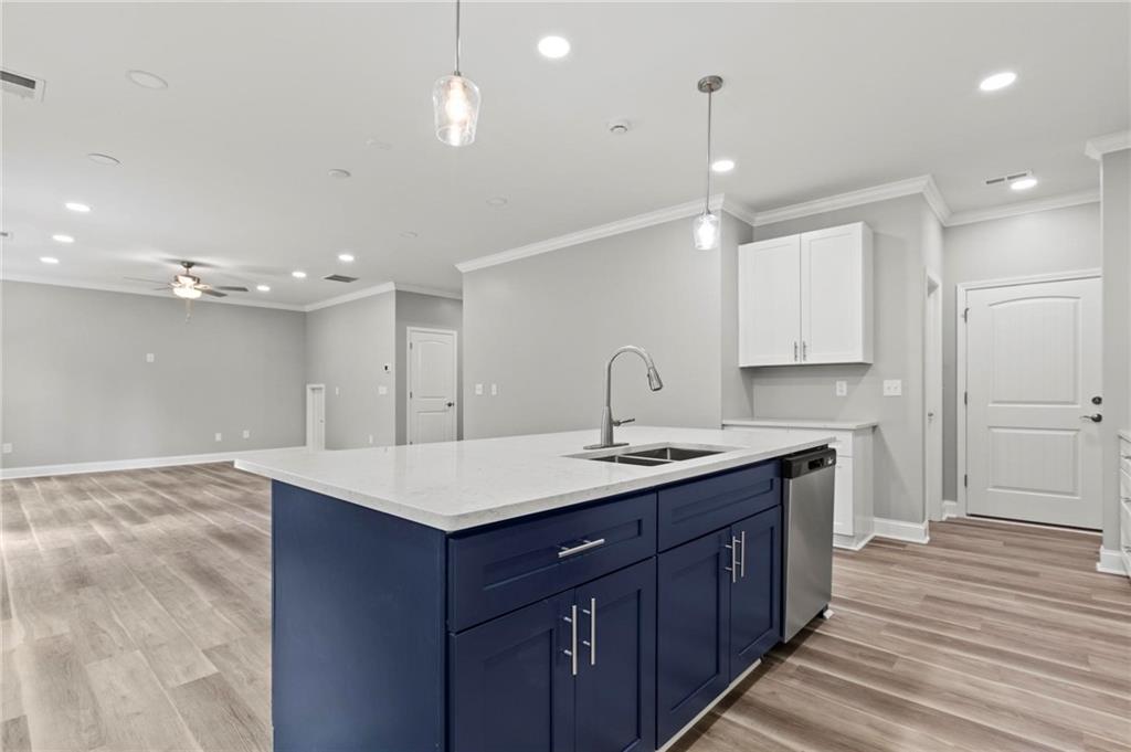 5341 Stewart Mill Road Douglasville, GA 30135 - Photo 12 of 36 a kitchen with a sink chandelier and wooden floor