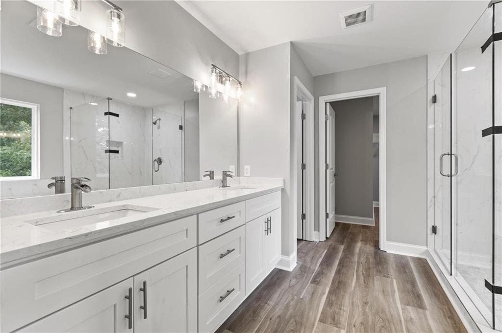 5341 Stewart Mill Road Douglasville, GA 30135 - Photo 21 of 36 a spacious bathroom with a double vanity sink and a mirror