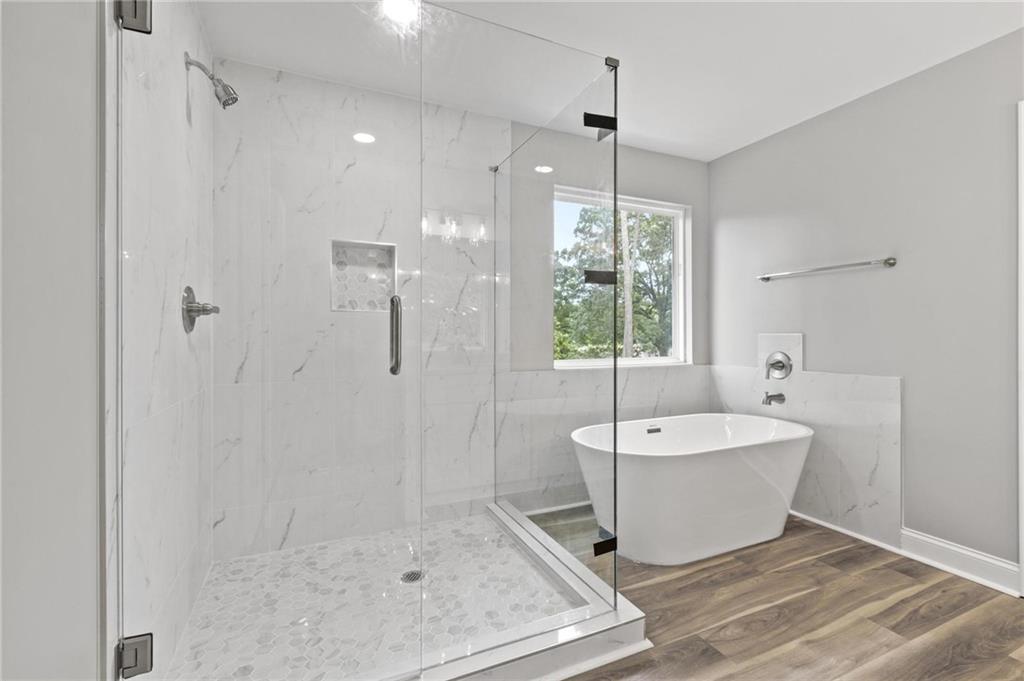 5341 Stewart Mill Road Douglasville, GA 30135 - Photo 22 of 36 a spacious bathroom with a bathtub and shower