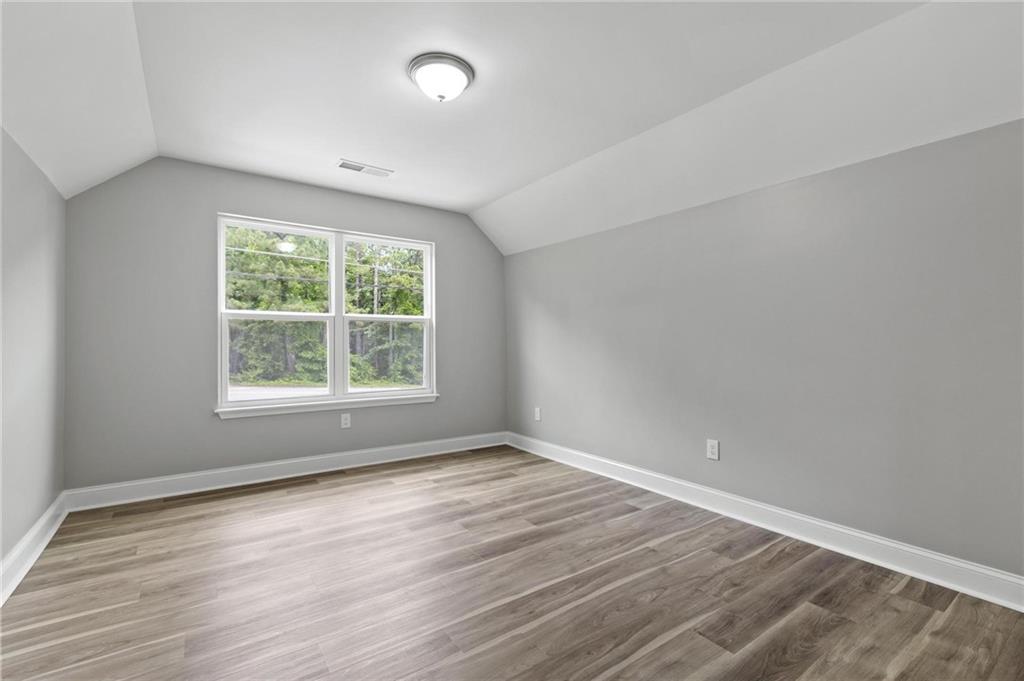 5341 Stewart Mill Road Douglasville, GA 30135 - Photo 30 of 36 an empty room with wooden floor and windows