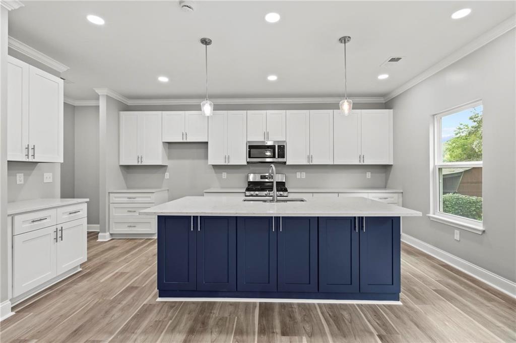5341 Stewart Mill Road Douglasville, GA 30135 - Photo 9 of 36 a kitchen with kitchen island sink stove and cabinets