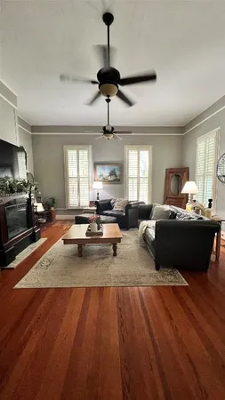 a living room with furniture and a wooden floor