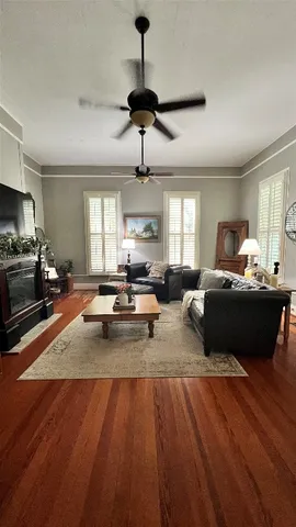 a living room with furniture and a wooden floor