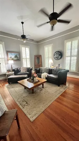 a living room with fireplace furniture and a large window