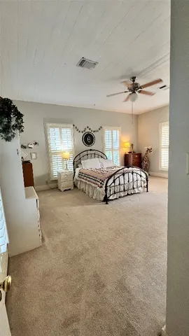 a spacious bedroom with a bed and a couch