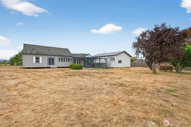 a view of a patio with lawn chairs under an umbrella