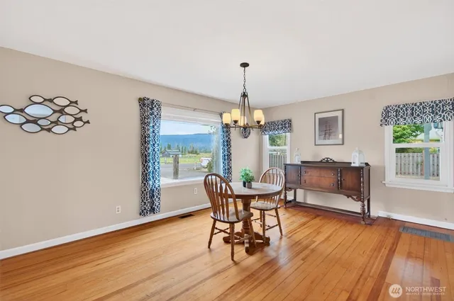 a view of a dining room with furniture wooden floor and chandelier