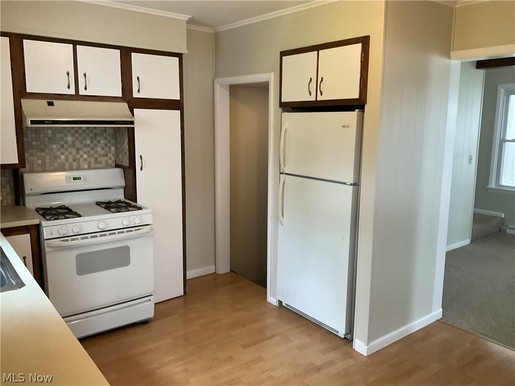 3475 South Turner Road Canfield, OH 44406 - Photo 11 of 33 Kitchen featuring light colored carpet, white appliances, backsplash, and white cabinetry