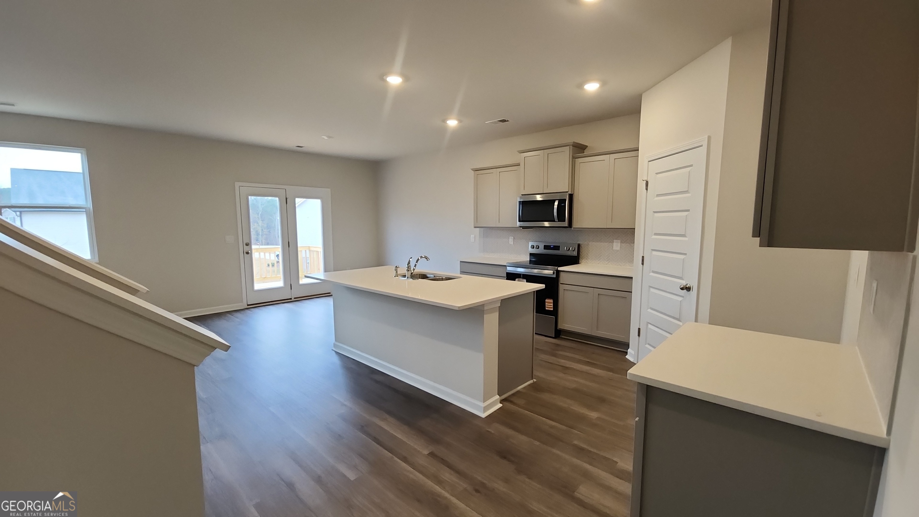 501 Vervain Drive, Unit 174 Locust Grove, GA 30248 - Photo 11 of 33 a kitchen with a refrigerator and a stove top oven