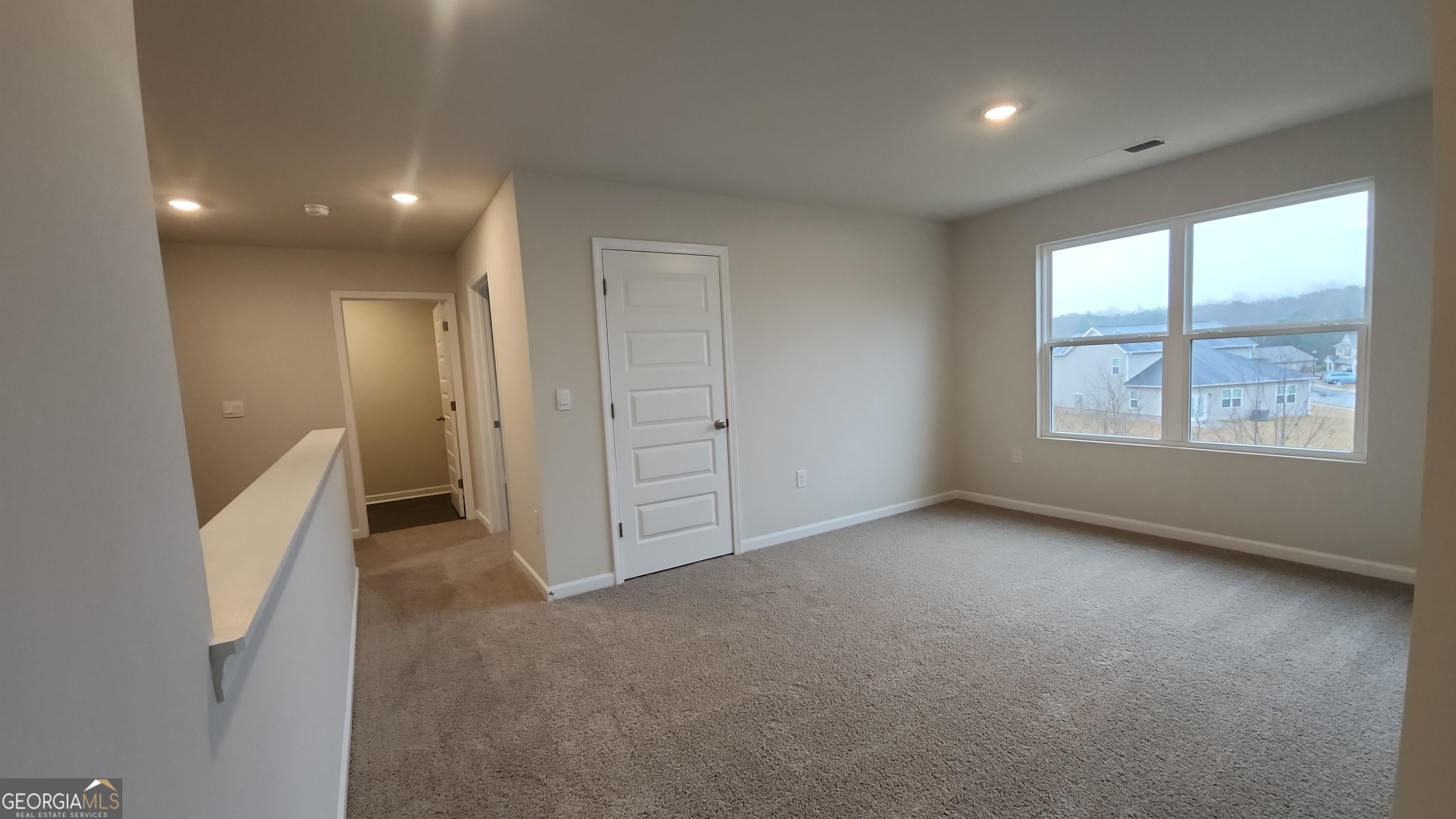 501 Vervain Drive, Unit 174 Locust Grove, GA 30248 - Photo 22 of 33 an empty room with windows and closet