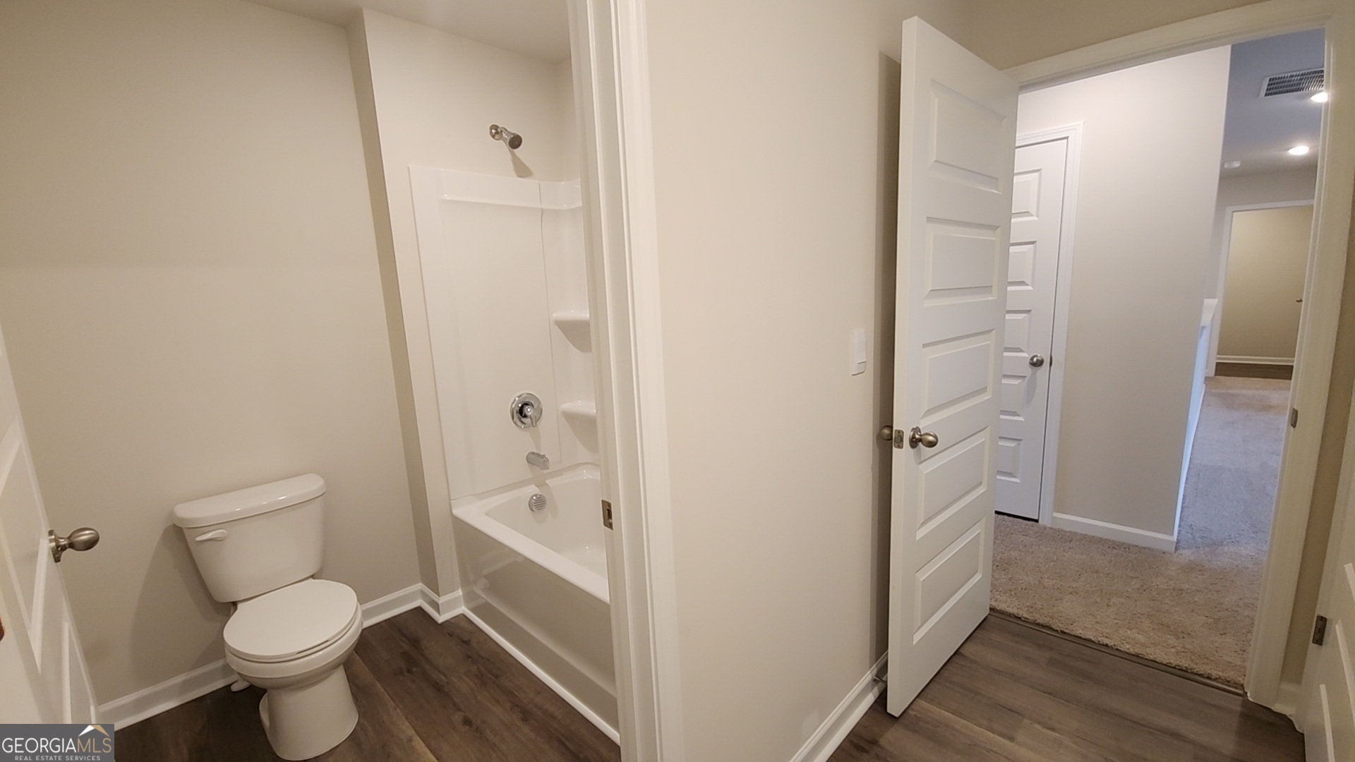 501 Vervain Drive, Unit 174 Locust Grove, GA 30248 - Photo 23 of 33 a bathroom with a toilet and a shower