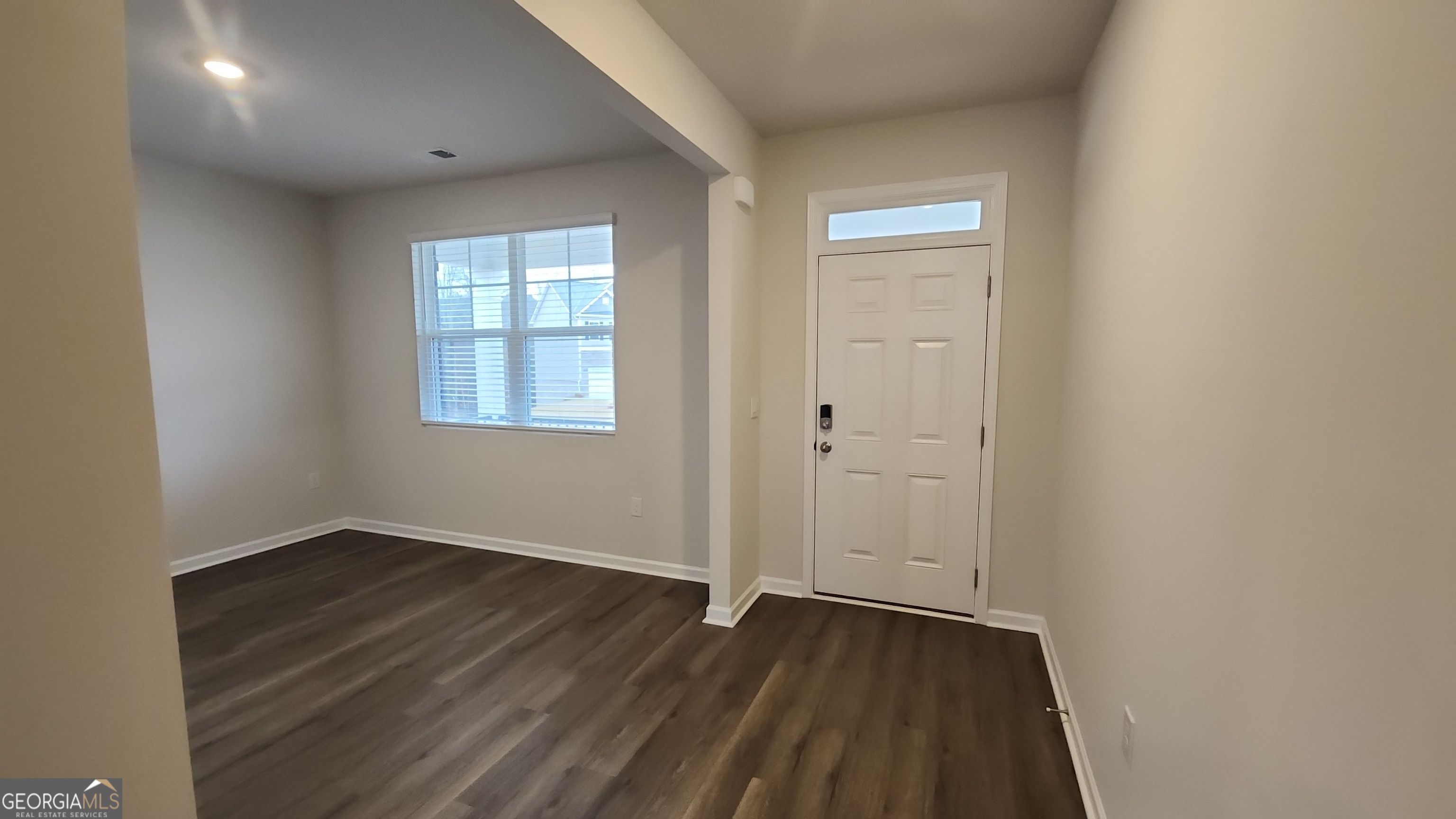 501 Vervain Drive, Unit 174 Locust Grove, GA 30248 - Photo 31 of 33 an empty room with wooden floor and windows
