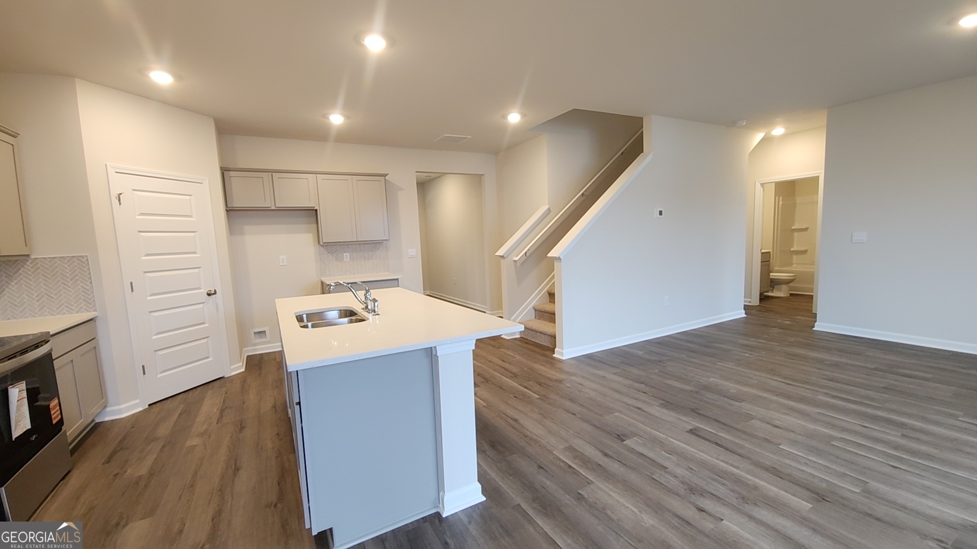 501 Vervain Drive, Unit 174 Locust Grove, GA 30248 - Photo 10 of 33 a view of a kitchen with a sink and an empty room