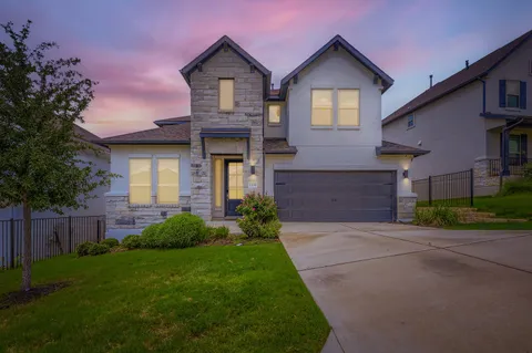 a front view of a house with a yard and garage