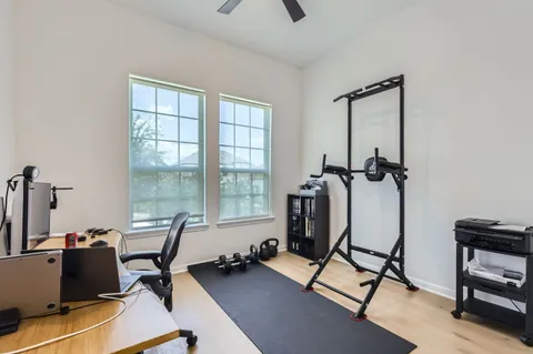 a view of a workspace with furniture and a window