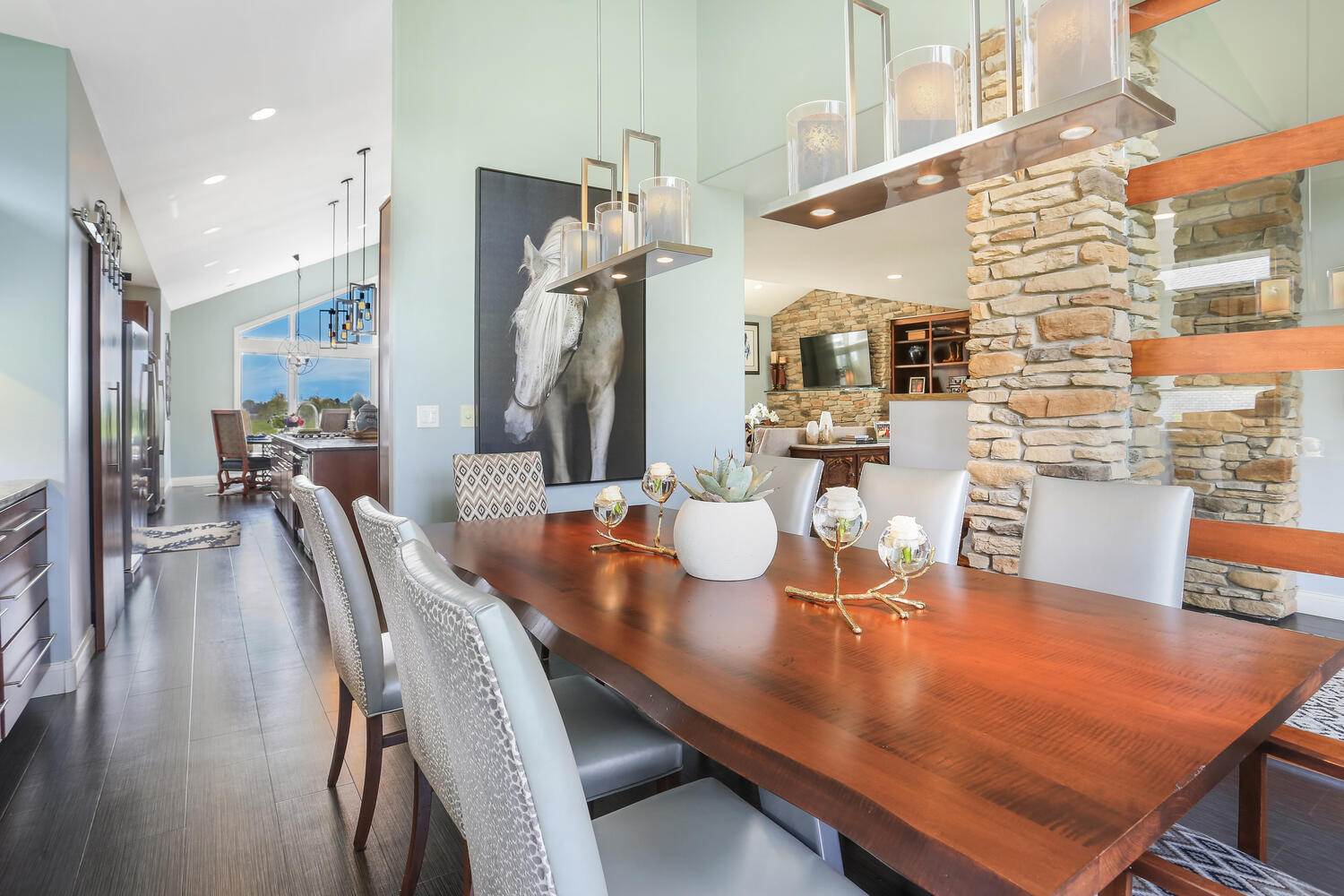 1411 Cross Creek Road Mahomet, IL 61853 - Photo 18 of 70 a dining room with stainless steel appliances kitchen island granite countertop a table chairs and a view of living room