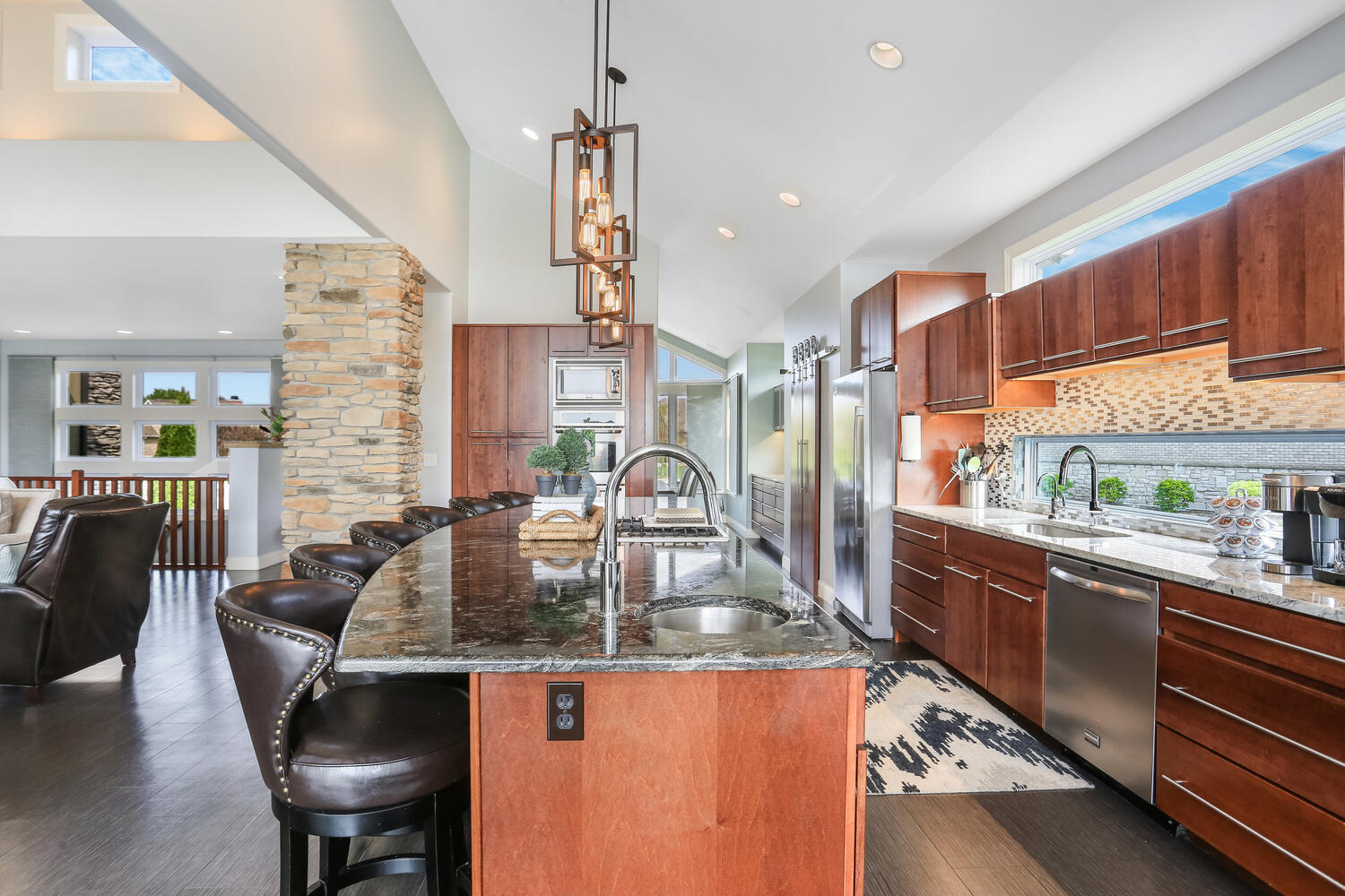 1411 Cross Creek Road Mahomet, IL 61853 - Photo 23 of 70 a kitchen with granite countertop kitchen island stainless steel appliances a table and chairs