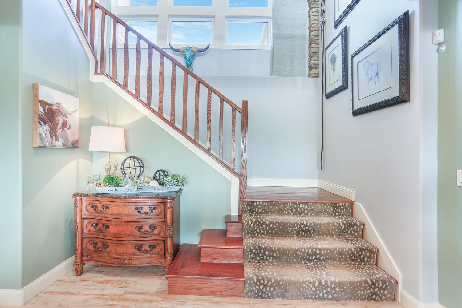 1411 Cross Creek Road Mahomet, IL 61853 - Photo 49 of 70 a view of staircase with lots of frames on wall and a potted plant