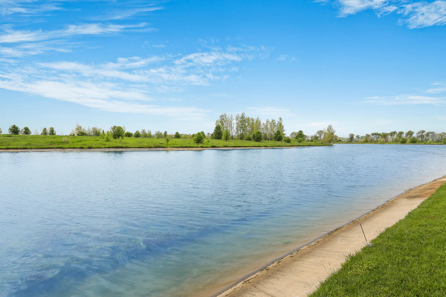 1411 Cross Creek Road Mahomet, IL 61853 - Photo 6 of 70 a view of a lake with houses in the back