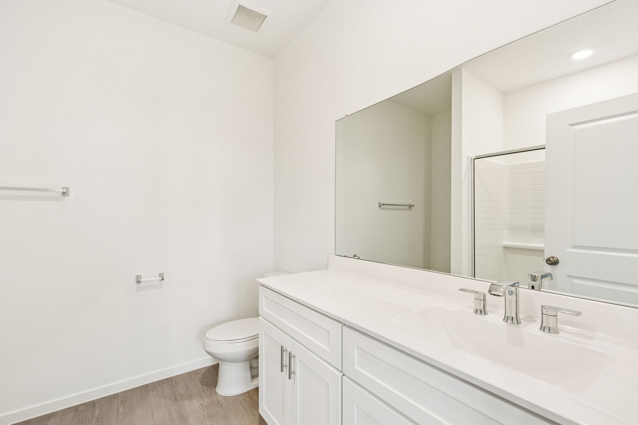 14985 Rustic Moon Road Conroe, TX 77302 - Photo 17 of 32 a bathroom with a granite countertop sink a toilet and a mirror