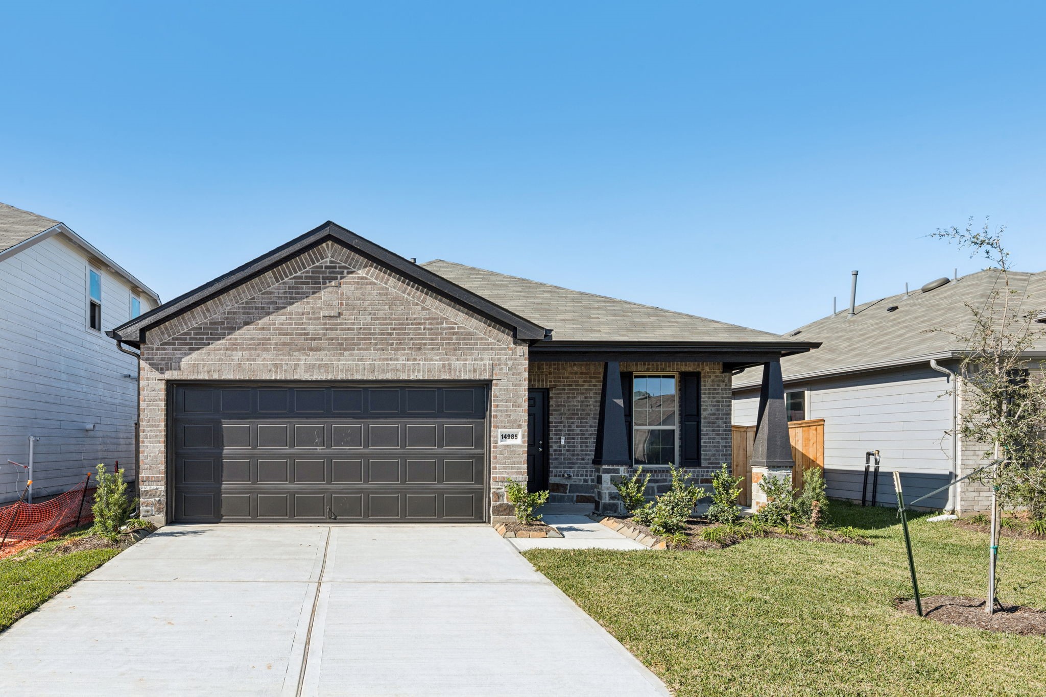 14985 Rustic Moon Road Conroe, TX 77302 - Photo 2 of 32 a front view of a house with garden