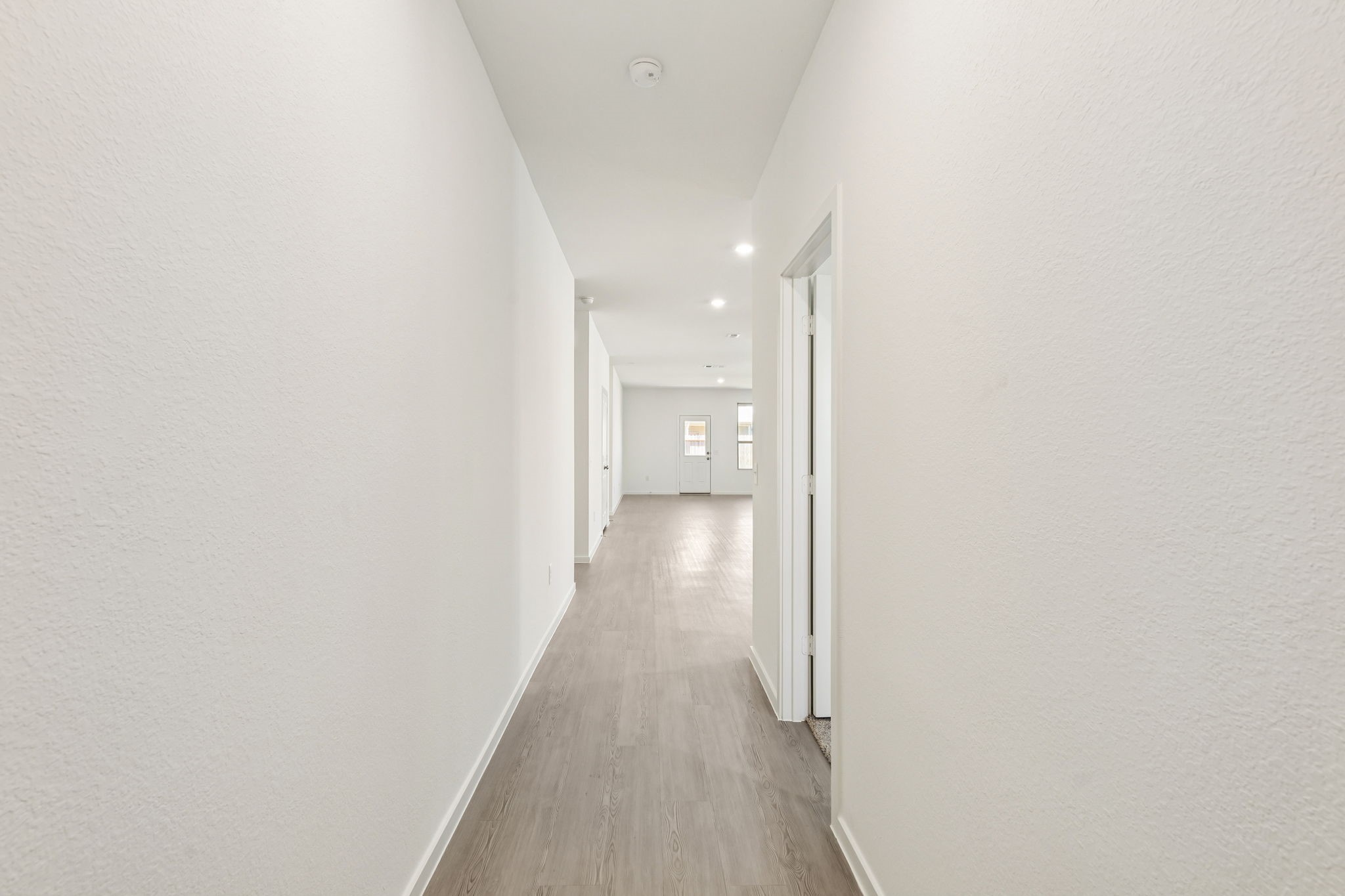 14985 Rustic Moon Road Conroe, TX 77302 - Photo 3 of 32 a view of a hallway with wooden floor