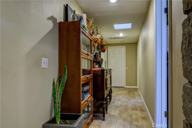 a bedroom with a bed wooden floor and window