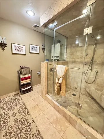 a view of a patio with table and chairs under an umbrella