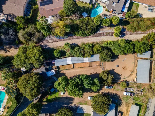 a front view of a house with a yard and potted plants
