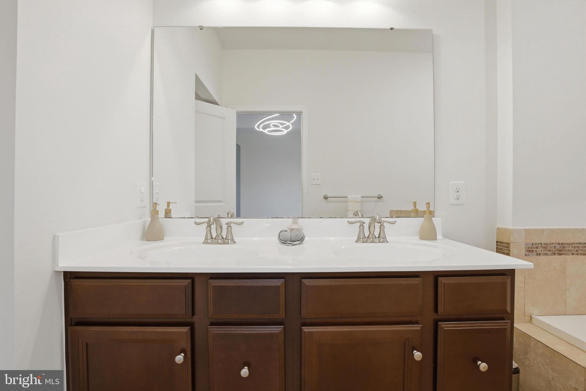 2784 Fredericksburg Road Hanover, MD 21076 - Photo 36 of 60 a bathroom with a sink and a mirror