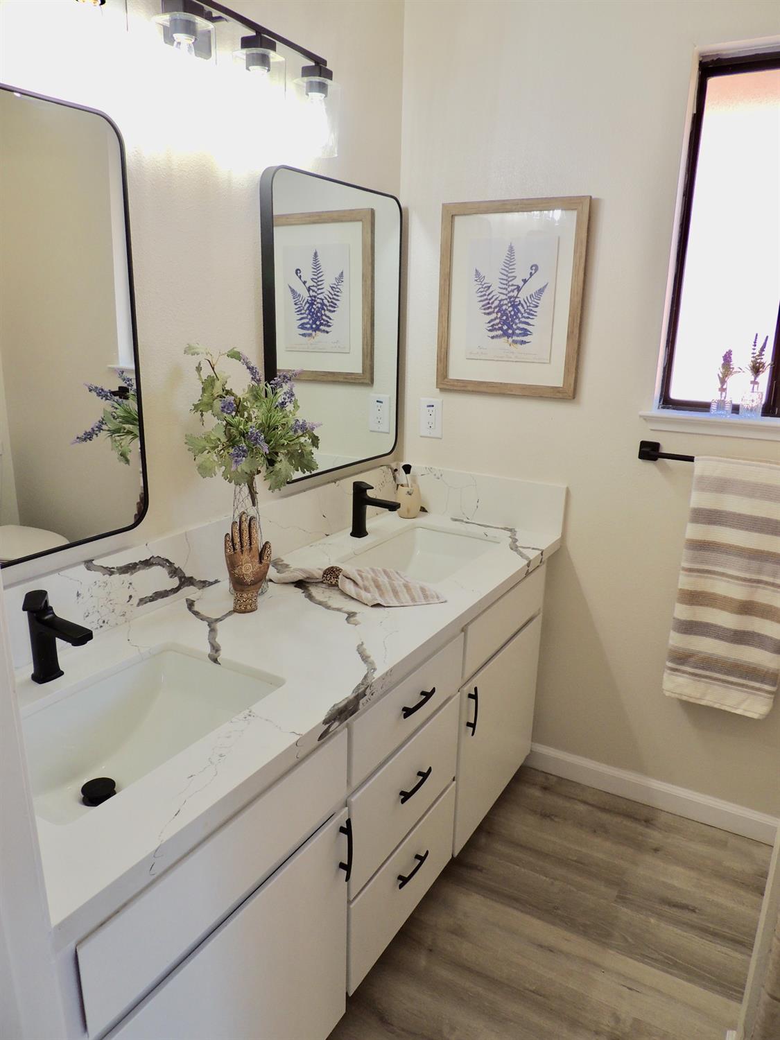 2395 Keats Avenue Clovis, CA 93611 - Photo 11 of 22 a bathroom with a double vanity sink and a mirror