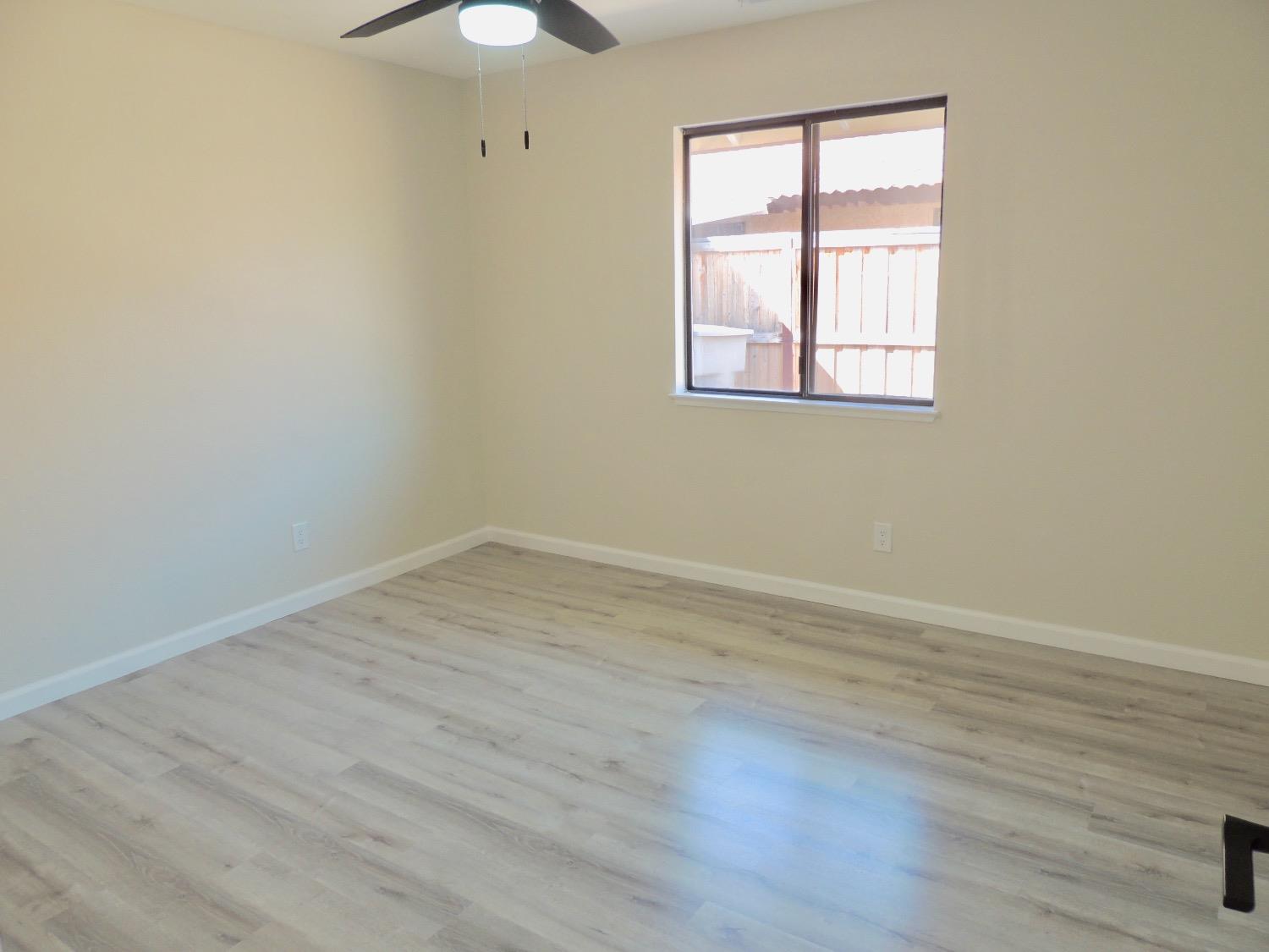 2395 Keats Avenue Clovis, CA 93611 - Photo 12 of 22 wooden floor in an empty room with a window