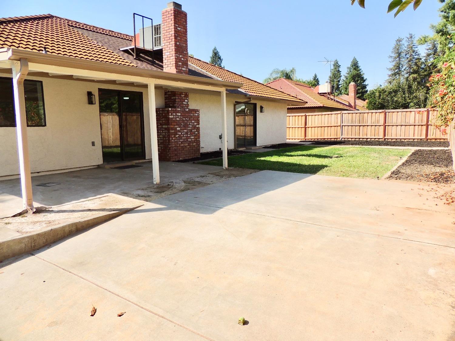 2395 Keats Avenue Clovis, CA 93611 - Photo 16 of 22 a view of a house with a small yard and wooden fence