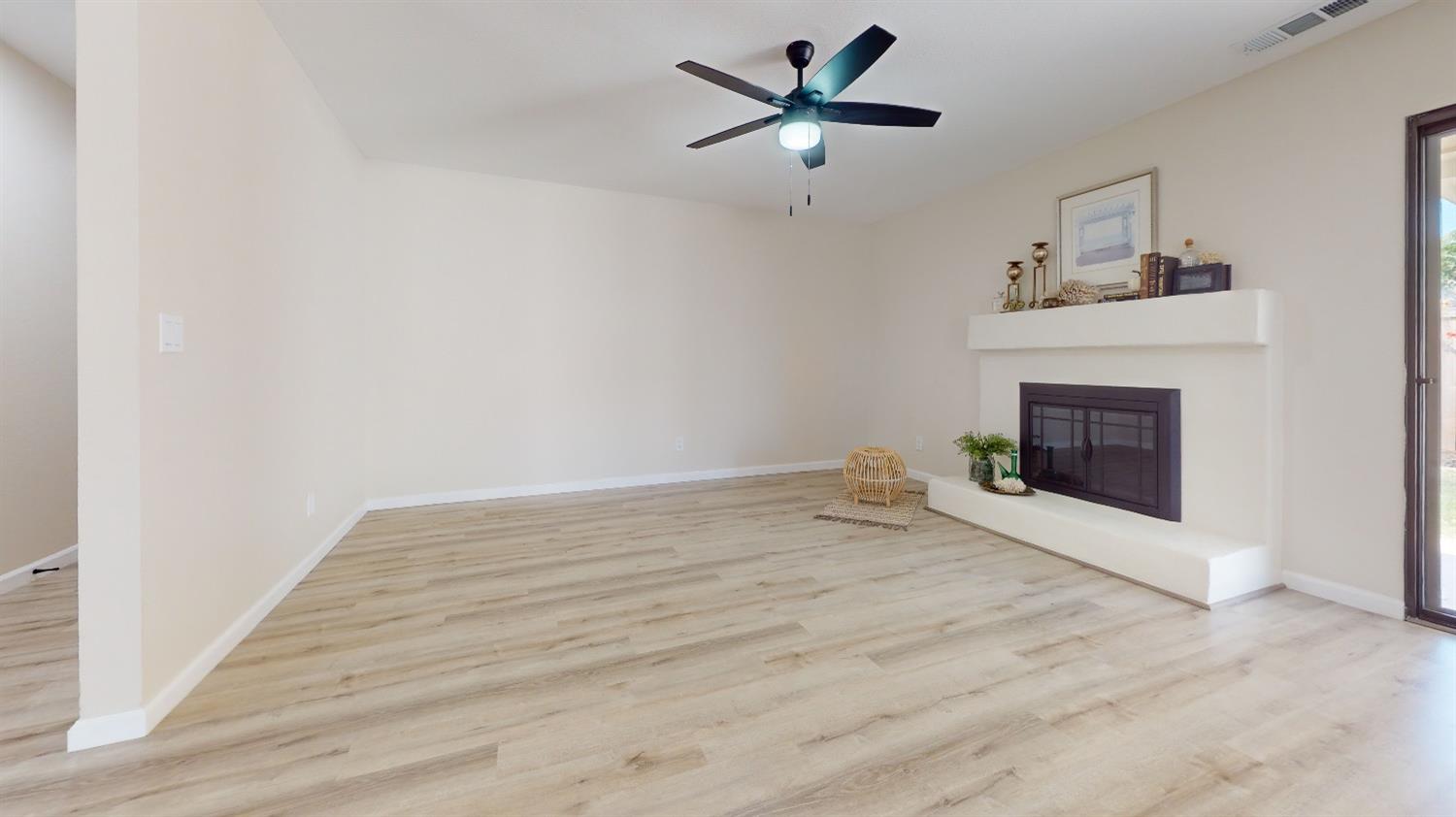 2395 Keats Avenue Clovis, CA 93611 - Photo 3 of 22 a view of empty room with fireplace and fan