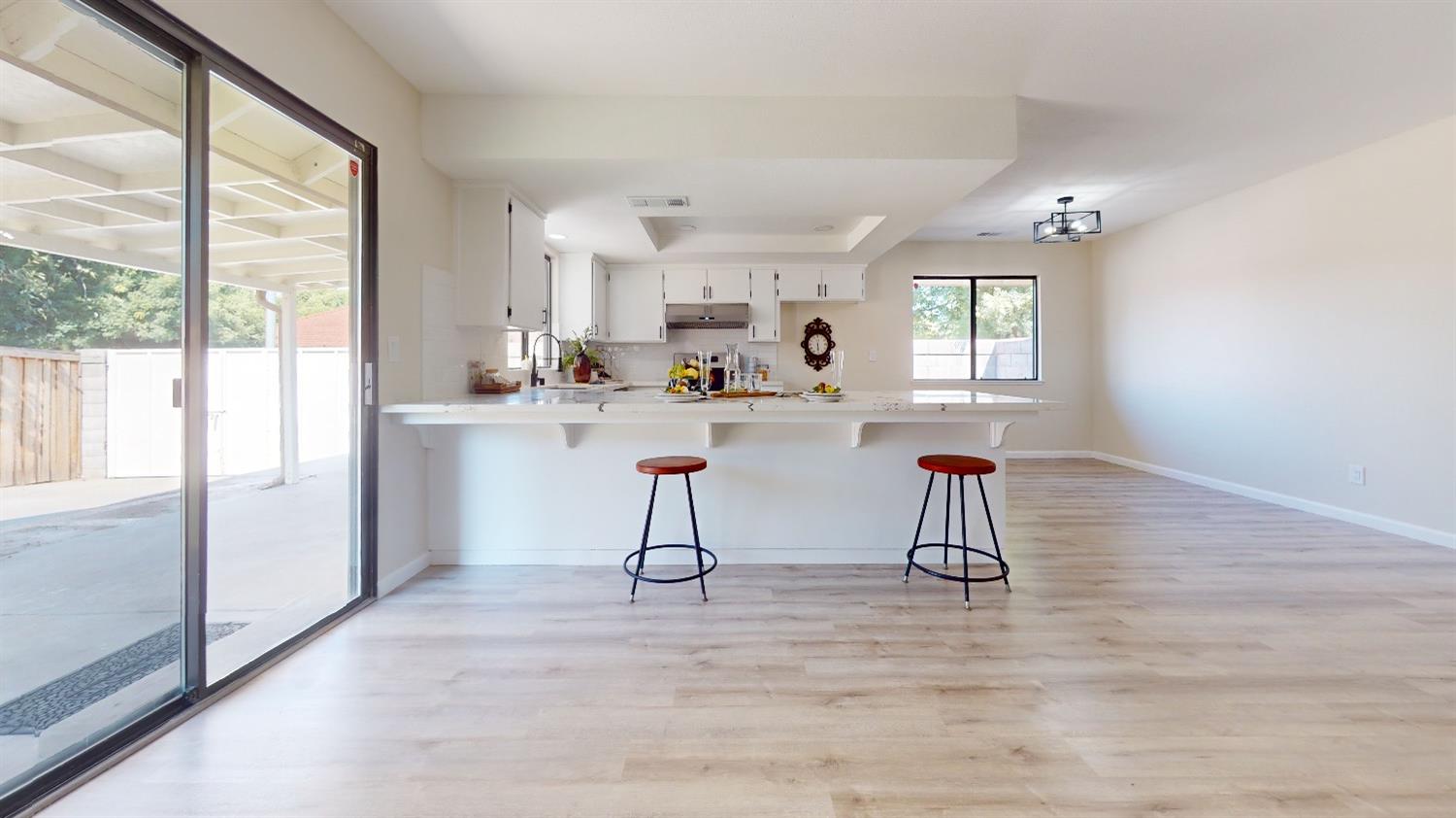 2395 Keats Avenue Clovis, CA 93611 - Photo 6 of 22 a workspace with furniture a chandelier and wooden floor