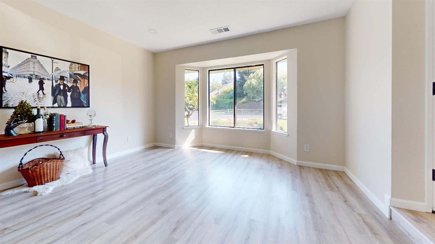 2395 Keats Avenue Clovis, CA 93611 - Photo 7 of 22 a view of an empty room with window and wooden floor