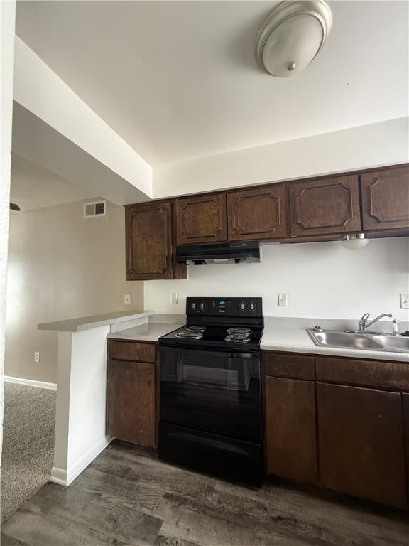 603 East 29th Street, Unit 4 Bryan, TX 77803 - Photo 3 of 8 a kitchen with stainless steel appliances granite countertop a sink and a stove