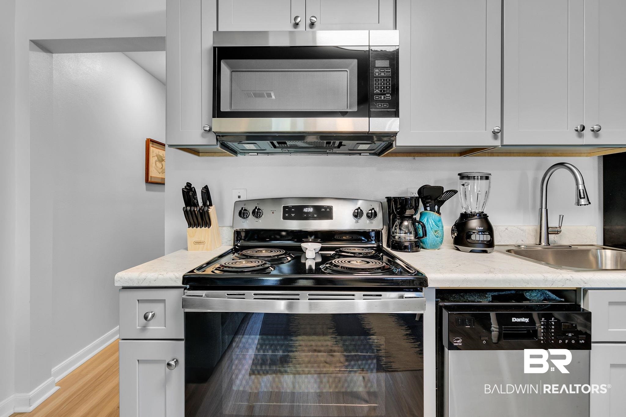 400 Plantation Road, Unit 4115 Gulf Shores, AL 36542 - Photo 14 of 48 Kitchen featuring light wood-type flooring, sink, stainless steel appliances, and light stone countertops
